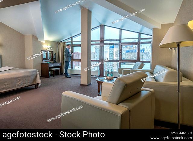 Image of successful businessman in luxury hotel room