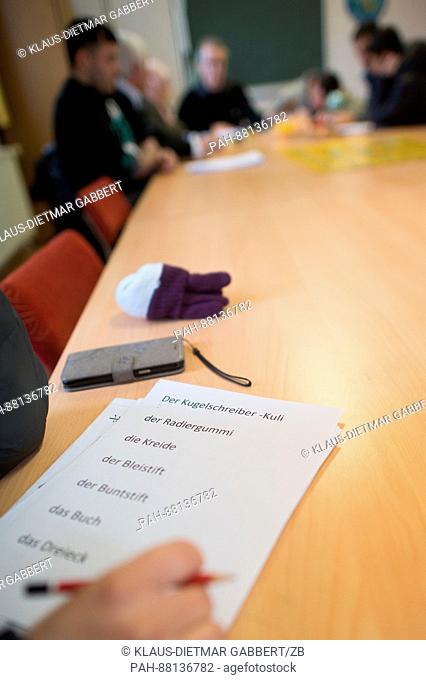 A worksheet with German words lies on a table during a German lesson in the community hall of the St. Elizabeth Catholic parish in Tangermuende, Germany