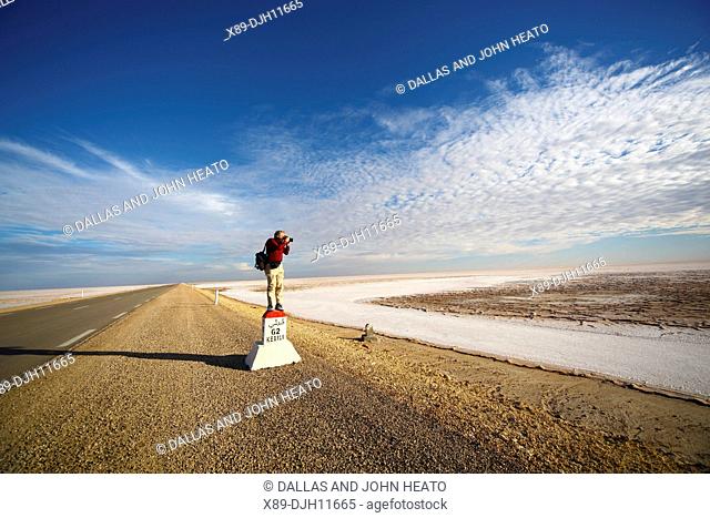 Africa, Tunisia, Chott El Jerid, Flat Dry Salt Lake between Tozeur and Kebili, Photographer on Signpost