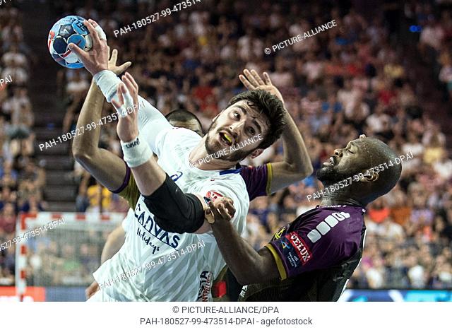 27 May 2018, Germany, Cologne: Handball Champions League final, HBC Nantes vs Montpellier HB at the Lanxess Arena: Rock Feliho (r) of Nantes and Ludovic...