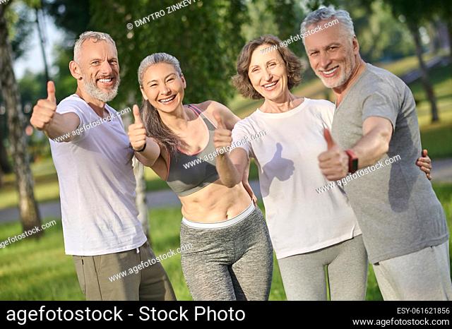 Sports in the park. Group of people spending time together in the park and looking happy