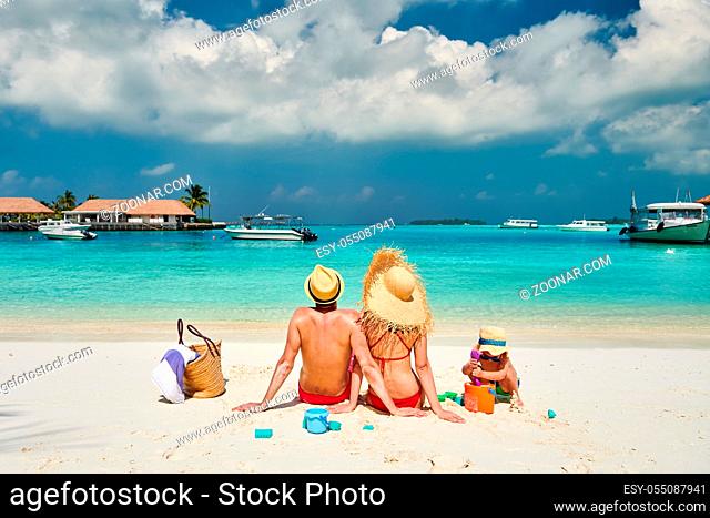 Family on beach, young couple with three year old boy. Summer vacation at Maldives
