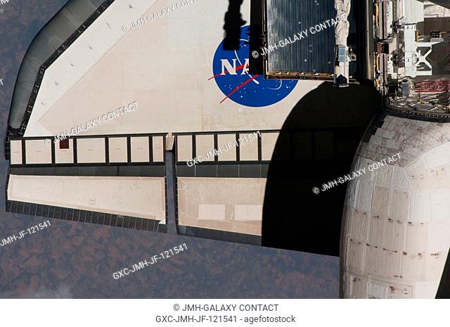 This partial view of the port wing of the space shuttle Discovery was provided by an Expedition 23 crew member during a survey of the approaching STS-131...