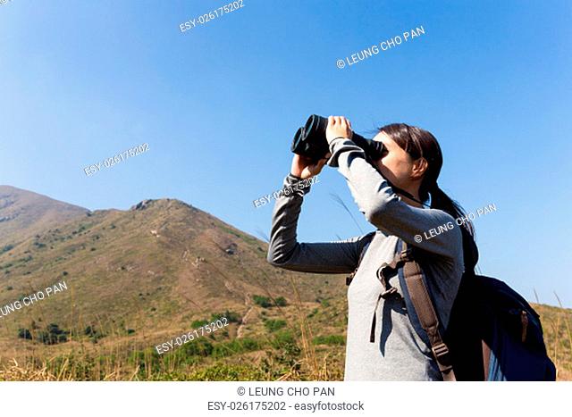Young Woman looking though the binocular