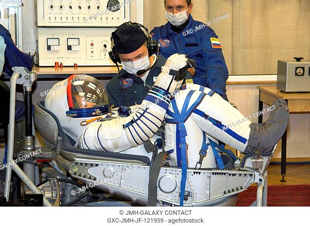 NASA astronaut Peggy A. Whitson, Expedition 16 commander, has a pressure suit leak check performed on her Russian Sokol launch and entry suit at RSC Energia...