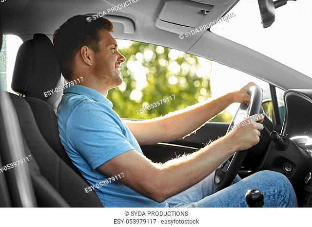 smiling man or driver driving car