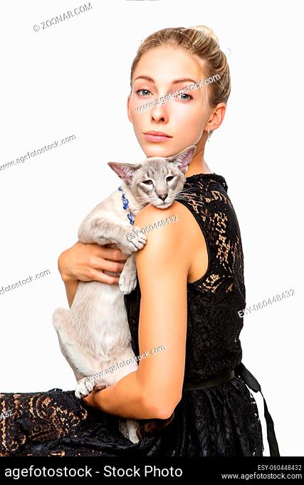 Beautiful blond girl with oriental siam cat isolated on white background. Copy space