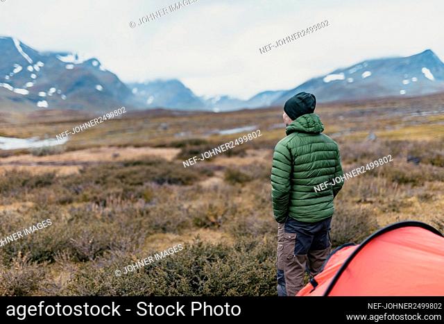 Hiker in mountains looking at view