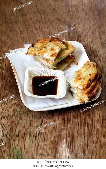 Cong you bing (fried spring onion unleavened bread with a soy dip, China)