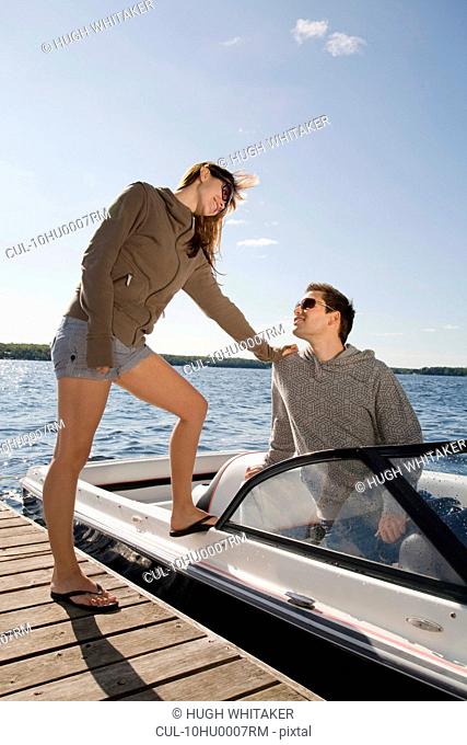 Couple with speedboat next to dock