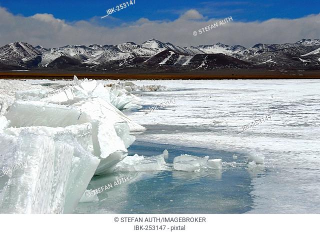 Floes in frozen Nam Tso Lake in front of Nyenchen Tanglha mountains Tashi Dor Tibet China