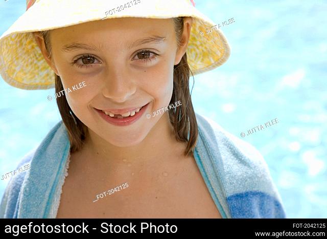 Young girl with hat and towel around shoulders
