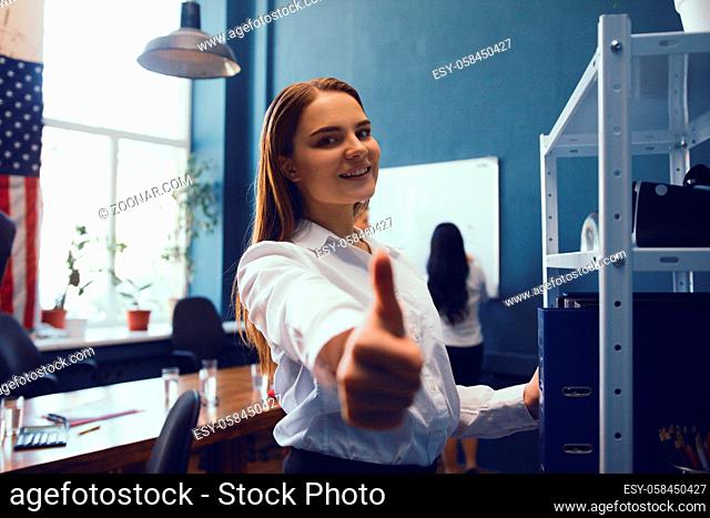 Beautiful Business Woman Showing Thumb Up While Being In Office. Business Concept