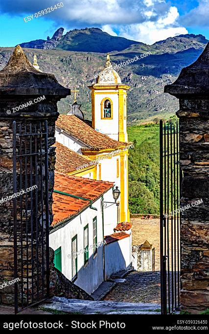 View of one of several churches and your bell tower in baroque and colonial architecture of the city of Ouro Preto in Minas Gerais with its mountains in the...