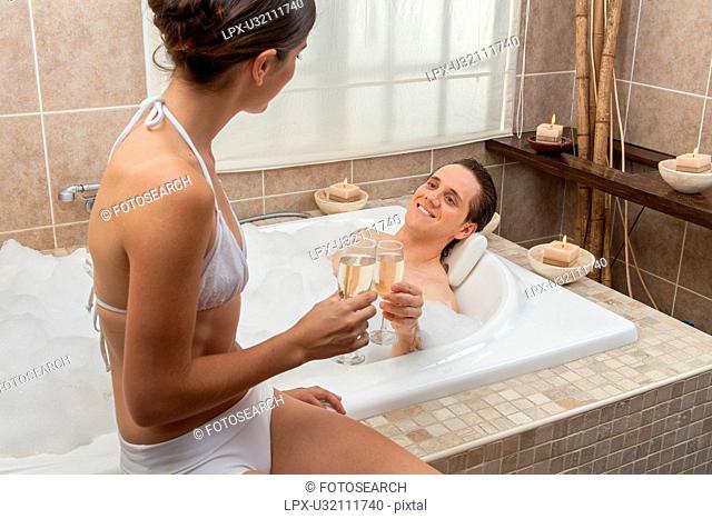 Couple making a toast in the tub