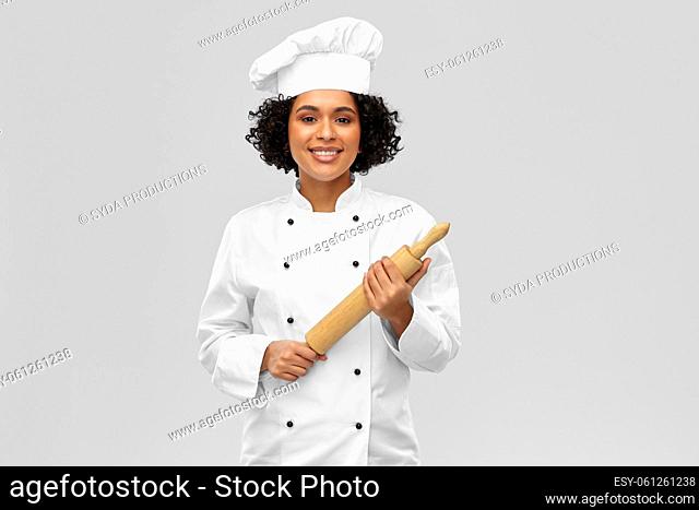 smiling female chef or baker with rolling pin