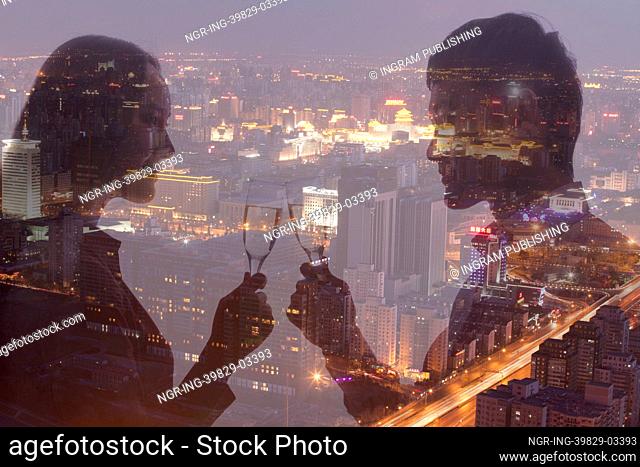 Double exposure of couple toasting with champagne flutes over night cityscape