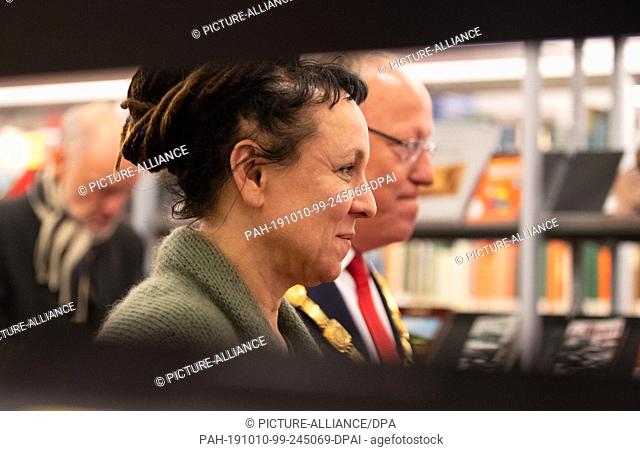 10 October 2019, North Rhine-Westphalia, Bielefeld: The Polish author Olga Tokarczuk walks past bookshelves in the run-up to a reading by the city library