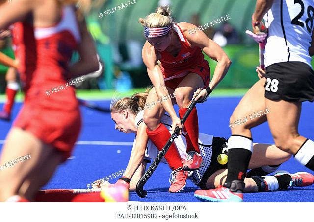 Franzisca Hauke of Germany (behind) vies for the ball against Kathleen Sharkey of the USA during Women's Field Hockey Quarterfinal match between the USA and...