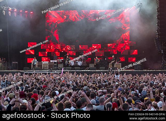 04 June 2023, Bavaria, Nuremberg: Visitors and fans stand in front of the stage during the performance of the Foo Fighters on the Utopia Stage at the closing of...