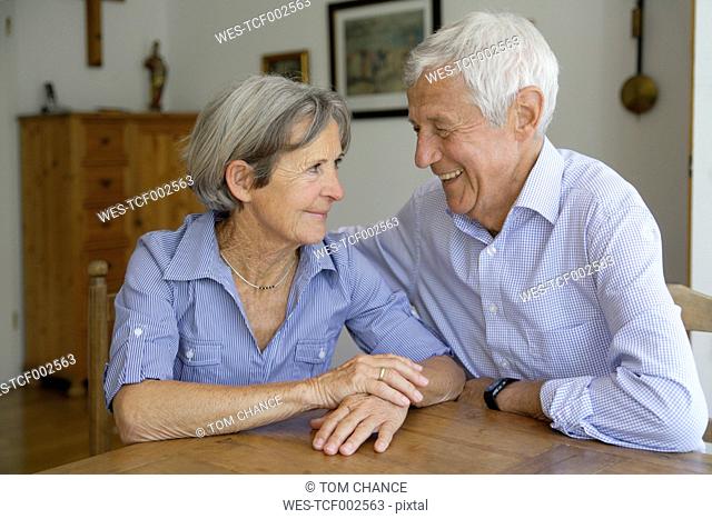 Germany, Bavaria, Senior couple looking at each other, smiling