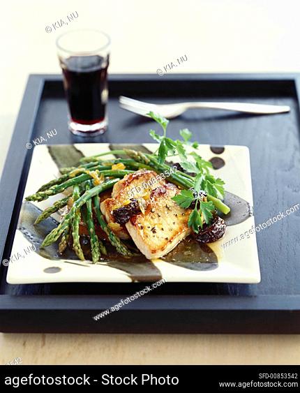 Pork cutlets with green asparagus and plum sauce