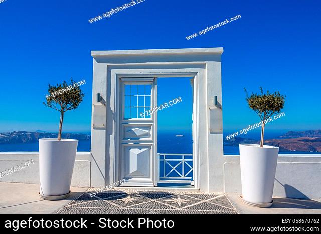 Greece. Summer sunny day on the caldera of Thira island (Santorini). Cafe entrance with a sea view