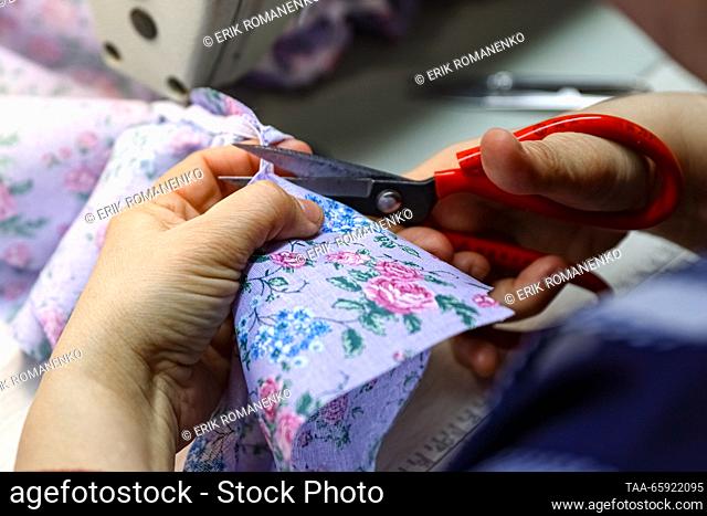 RUSSIA, VORONEZH - DECEMBER 19, 2023: An employee manufactures dolls clothes at the Igrushki factory. The enterprise is engaged in production of PVC plastisol...