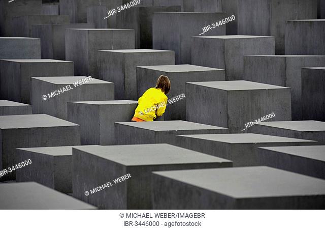 Memorial to the Murdered Jews of Europe, child playing hide and seek at the Holocaust Memorial designed by architect Peter Eisenman