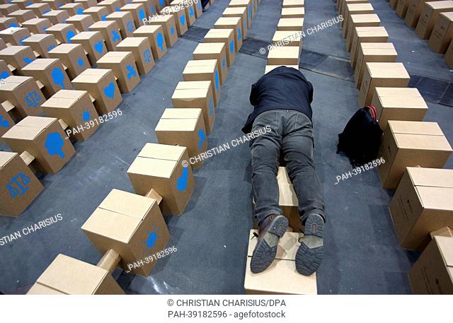 A convetion participant lies on cardboard stools after the event 'A strong society' at the 34th German Evangelical Church Congress in Hamburg, Germany