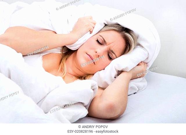 Woman with a bedsheet over her head