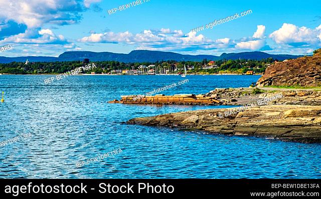 Oslo, Ostlandet / Norway - 2019/09/02: Panoramic view of Oslofjord harbor from rocky recreational cape of Hovedoya island with Londoya island in background