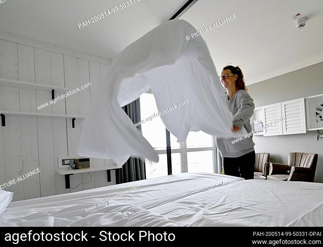 12 May 2020, Schleswig-Holstein, St.Peter-Ording: Kati Simon, hotel employee at the Beach Motel, prepares the beds in a hotel room for new guests