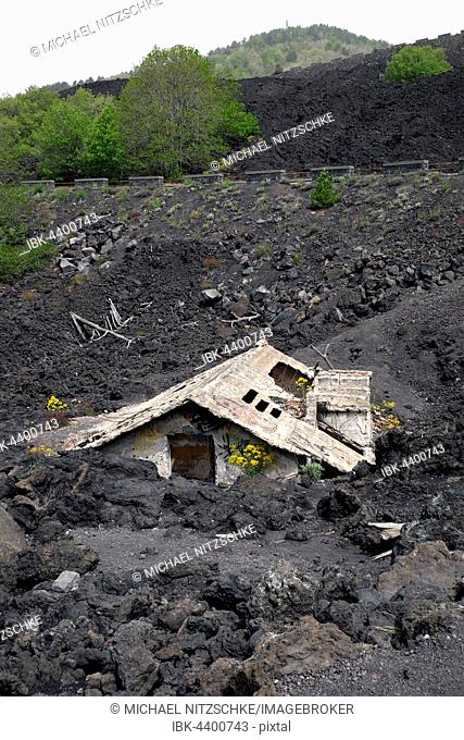 House covered with lava on the slopes of Mount Etna, Sicily, Italy