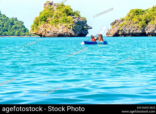 Two women are mother and daughter. Travel by boat with a kayak around island enjoy view the beautiful natural landscape of the blue sea at summer