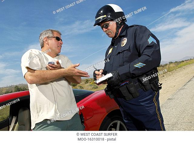 Traffic cop talking with driver of sports car