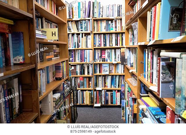 Interior of an Old Book Shop with shelves full of old books. England, UK, Europe