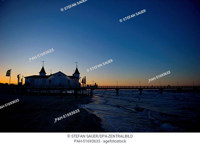 The sun sets above the pier of baltic sea spa town Ahlbeck on the island of Usedom, Germany, 03 September 2014. About 1, 6 million tourists visit the second...
