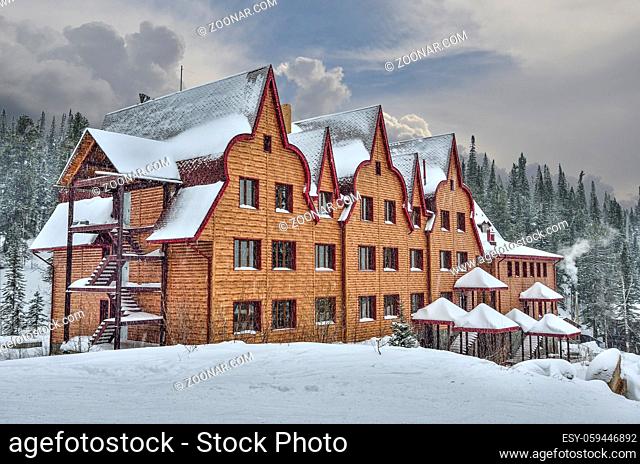 Ski resort Sheregesh, Green mountain, Gornaya Shoria, Kemerovo region, Russia - November 24, 2018: Beautiful winter mountain landscape on ski resort with hotel...
