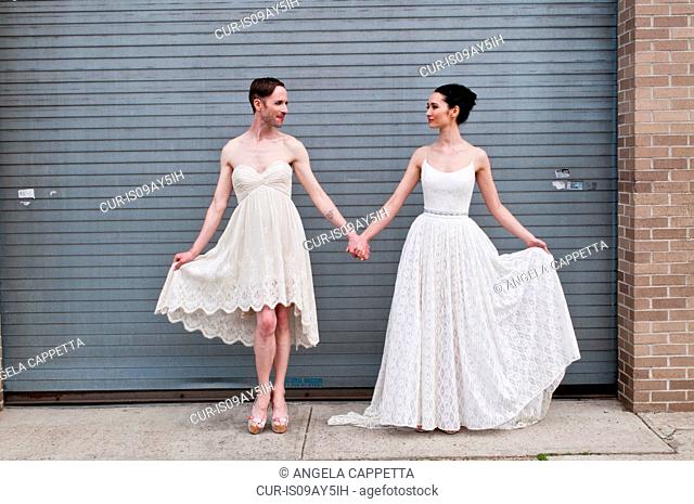 Gender fluid model and female model showing off cotton wedding dresses