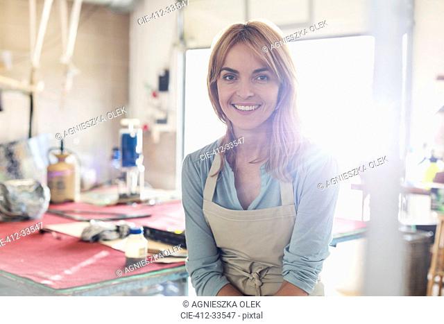 Portrait smiling artist in studio