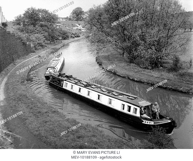 A pair of narrow boat, converted for holiday cruises by Messrs. Street of Leighton Buzzard, swinging round a bend in the Grand Union Canal, near Linslade