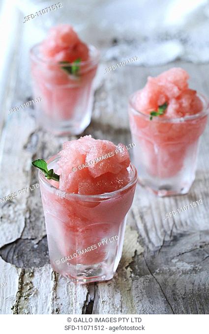 Watermelon granita in glasses on a wooden surface