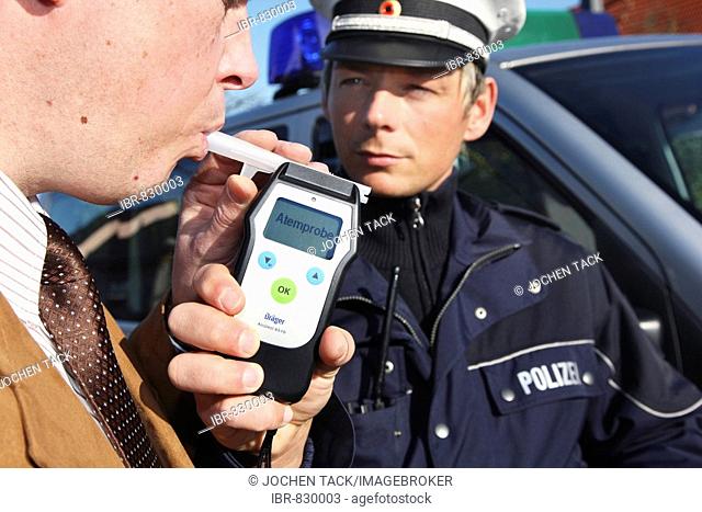 Alcohol breath test, driver being tested with a breathalyzer, breathalyser, Mettmann, North Rhine-Westphalia, Germany, Europe