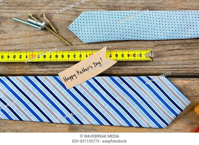 Overhead view of hand tools by neckties with fathers day greetings
