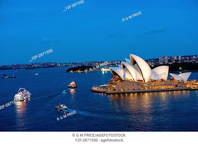 Sydney Harbour at dusk with boats and opera house