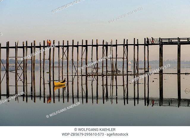 U Bein Bridge (built around 1850 and is believed to be the oldest and longest teakwood bridge in the world) reflecting in Taungthaman Lake near Amarapura