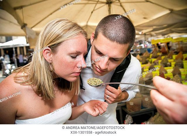 Couple smelling Italian herbs and spices
