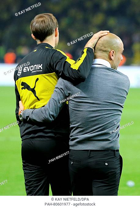 Munich's head coach Pep Guardiola (R) embraces his Dortmund counterpart Thomas Tuchel after the German DFB Cup final soccer match between Bayern Munich and...