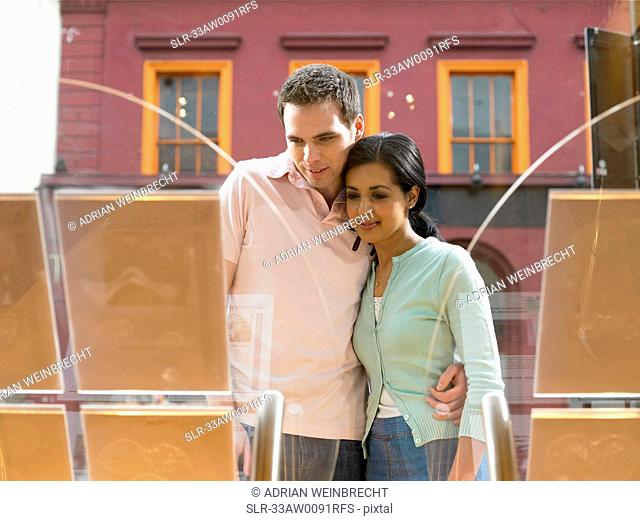 Couple examining window display